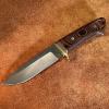 "THE PRIMITIVE" is a Loveless style drop point hunter forged from 52100 bearing steel which has 1.45% chromium for lower corrosion risk. The blade is left with the original hammer forged marks and triple quenched for superior edge holding. The guard is brass with mosaic pins. OAL is 9 1/2".  $350.